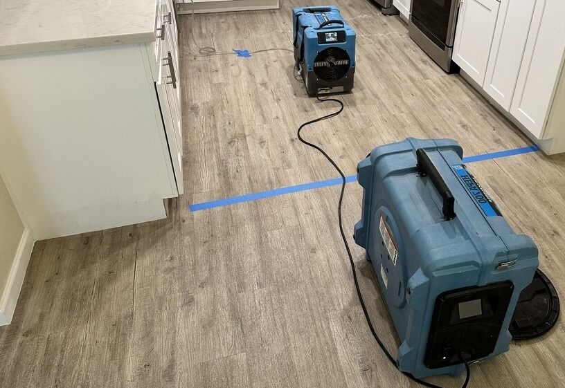 QuickDry water extraction and drying equipment set up in a Phoenix kitchen